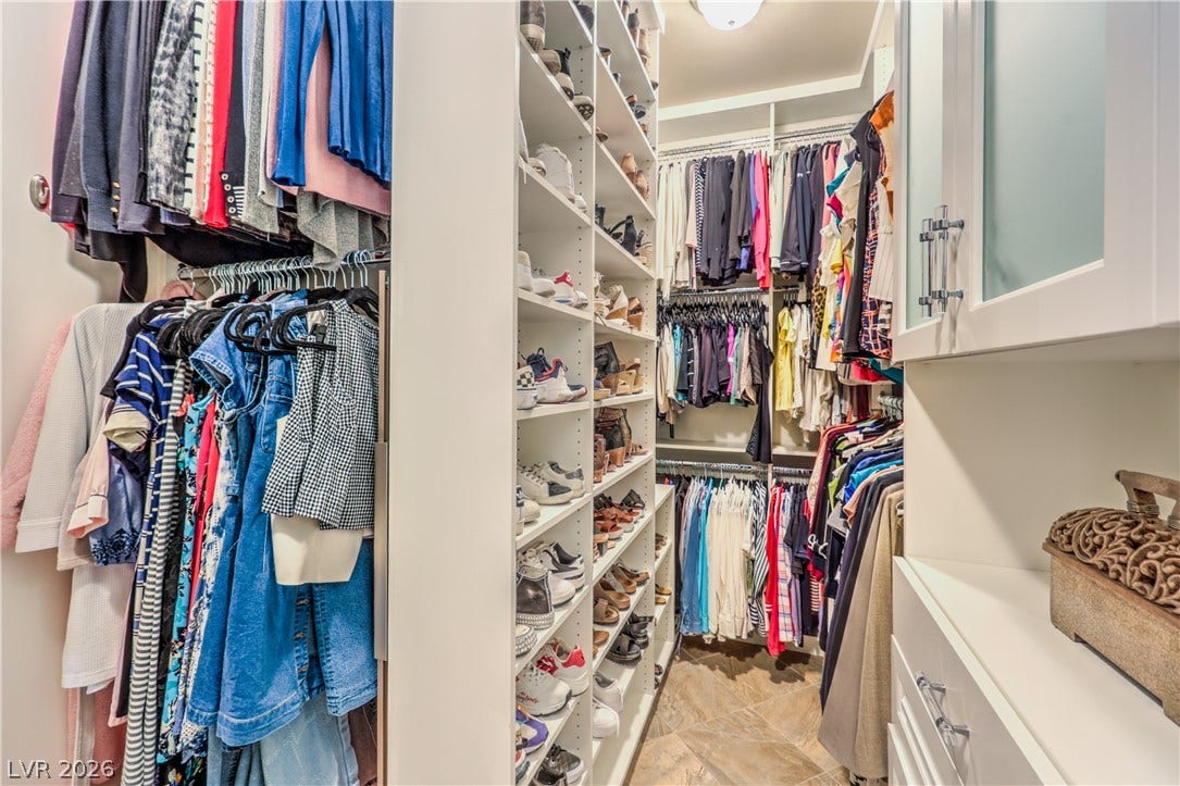 24 CROSS RIDGE Street, Las Vegas, NV 89135 Floor-to-ceiling built-ins and custom shelving optimize storage in this spacious walk-in closet.