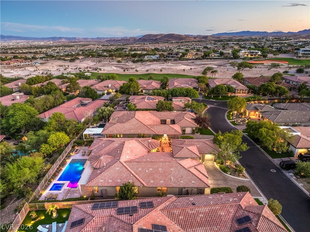 24 CROSS RIDGE Street, Las Vegas, NV 89135 Expansive desert vistas and surrounding mountains frame this tile-roofed neighborhood at twilight.