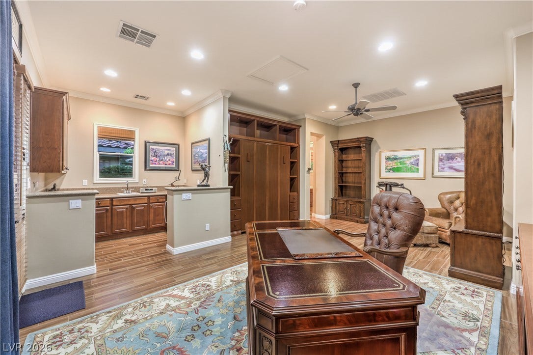 24 CROSS RIDGE Street, Las Vegas, NV 89135 Gleaming wood-look floors, recessed lighting, and custom built-in cabinetry define this functional home office workspace.