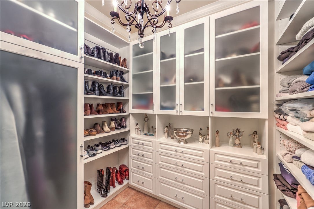 24 CROSS RIDGE Street, Las Vegas, NV 89135 Floor-to-ceiling custom cabinetry with frosted glass doors delivers abundant organized storage space.