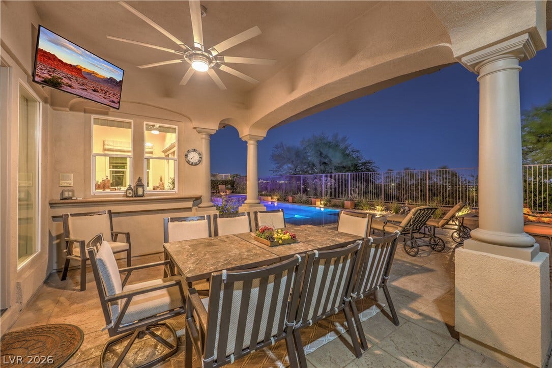 24 CROSS RIDGE Street, Las Vegas, NV 89135 Stately pillars frame a covered stone patio overlooking the backyard pool.