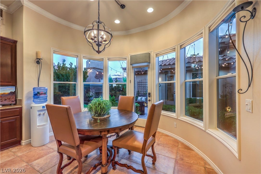 24 CROSS RIDGE Street, Las Vegas, NV 89135 Curved walls lined with large windows enclose a sunny dining space paved in tile flooring.