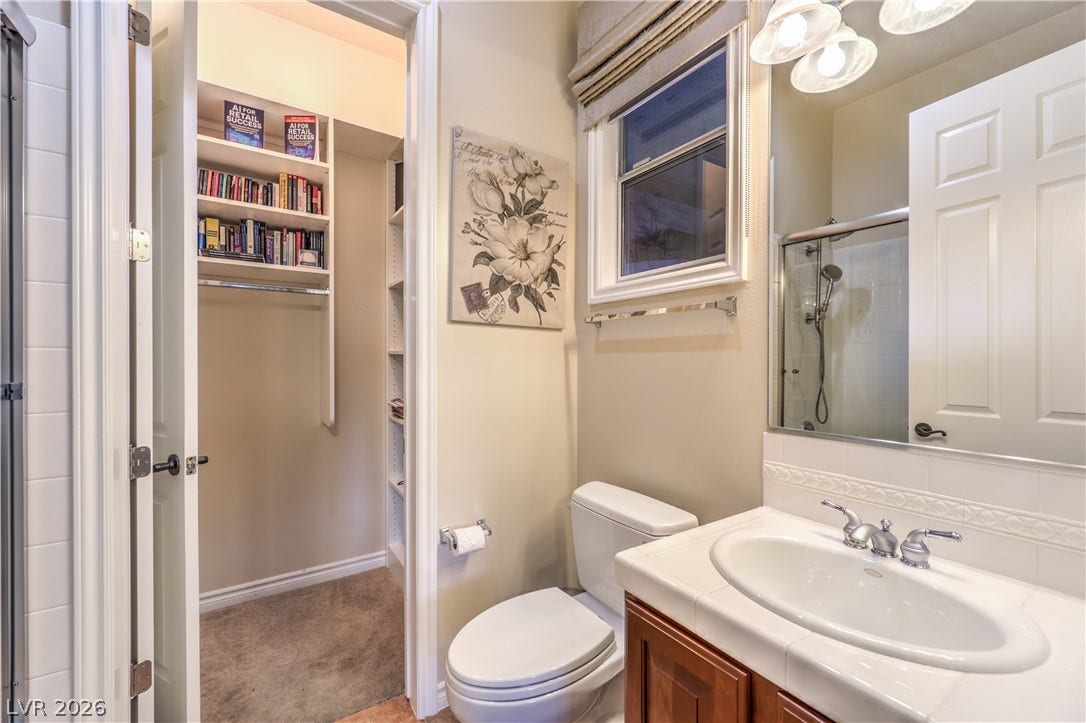 24 CROSS RIDGE Street, Las Vegas, NV 89135 Functional bathroom design connects directly to a built-in walk-in closet for ultimate convenience.