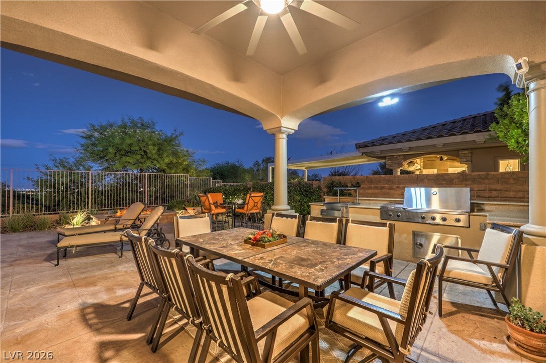 24 CROSS RIDGE Street, Las Vegas, NV 89135 A spacious covered patio anchors this outdoor living area complete with a built-in kitchen.