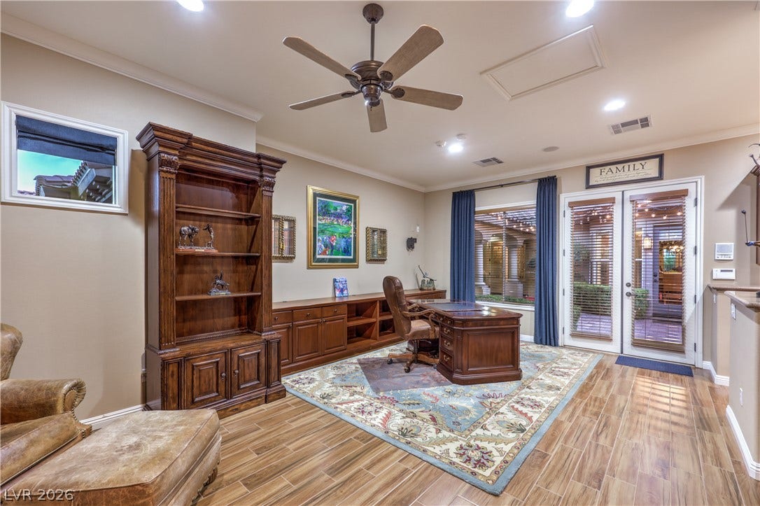 24 CROSS RIDGE Street, Las Vegas, NV 89135 Rich wood details and a customized built-in desk wall define this handsome workspace.
