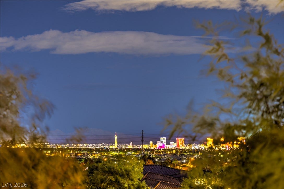 24 CROSS RIDGE Street, Las Vegas, NV 89135 Glittering city lights frame the distant skyline from this elevated vantage point.