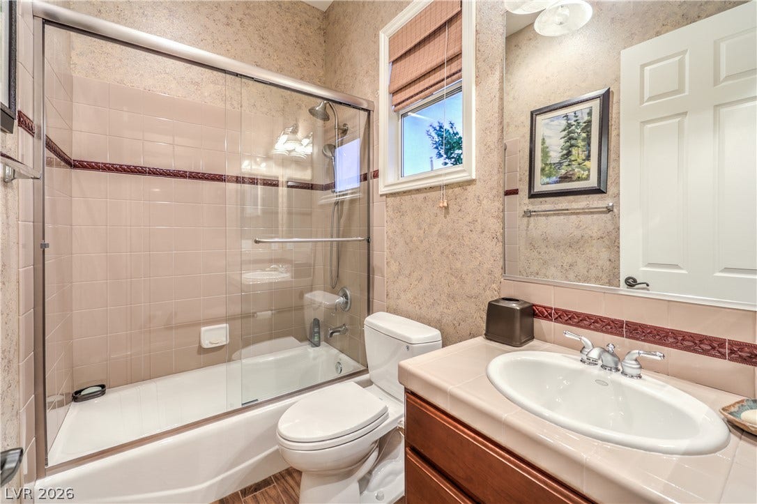 24 CROSS RIDGE Street, Las Vegas, NV 89135 Textured walls and tiled surfaces define this comfortable full bathroom.