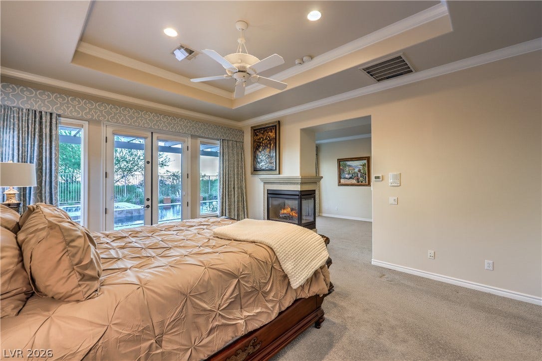 24 CROSS RIDGE Street, Las Vegas, NV 89135 French doors and a double-sided fireplace highlight this elegant master suite.