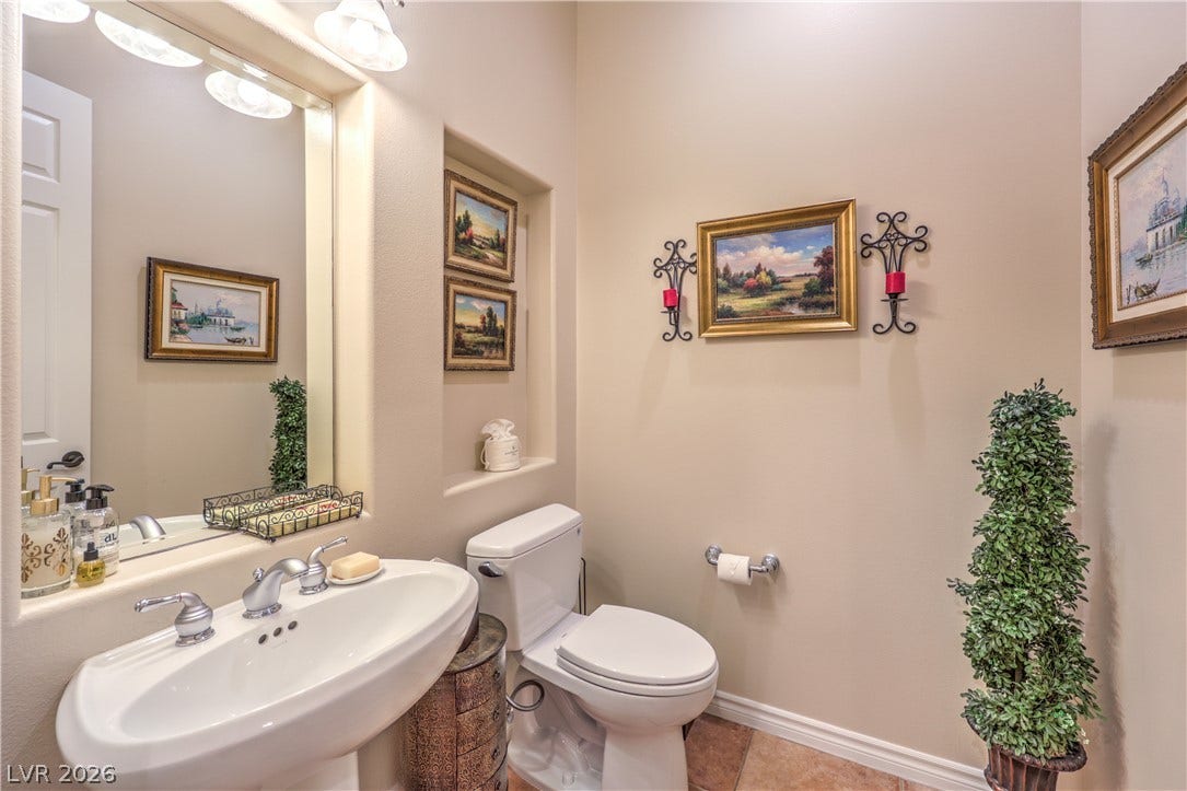 24 CROSS RIDGE Street, Las Vegas, NV 89135 A classic pedestal sink paired with neutral tile flooring graces this charming powder room.