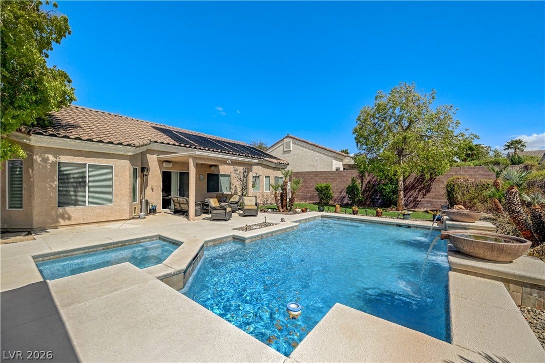 2201 Double Tree Avenue, Henderson, NV 89052 A sparkling swimming pool and separate spa anchor this private desert backyard retreat.