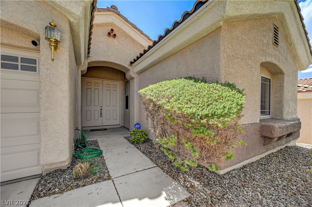 2201 Double Tree Avenue, Henderson, NV 89052 A concrete walkway leads to double entry doors beneath a classic tiled roofline.