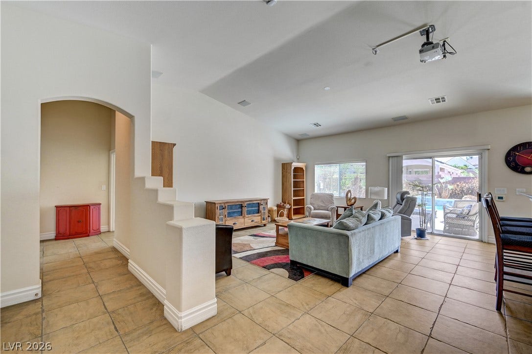 2201 Double Tree Avenue, Henderson, NV 89052 An open living area features durable tile flooring and high, vaulted ceilings.