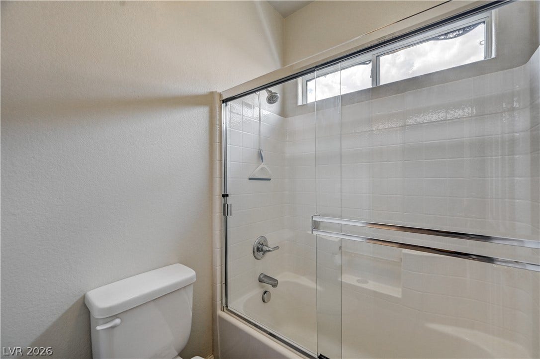 2201 Double Tree Avenue, Henderson, NV 89052 Clean lines and a clerestory window define this modern bathroom with a tub-shower combination.