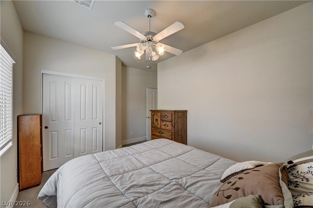 2201 Double Tree Avenue, Henderson, NV 89052 Carpeted floors and neutral walls anchor this secondary bedroom featuring built-in closet storage.