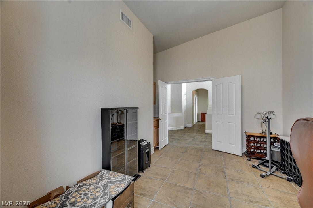 2201 Double Tree Avenue, Henderson, NV 89052 Double doors open from this versatile space onto an expansive tile-floored hallway.