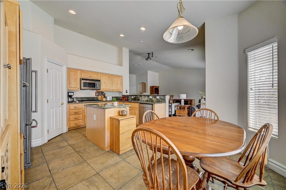 2201 Double Tree Avenue, Henderson, NV 89052 Tile flooring flows from the open-concept kitchen into this comfortable dining space.