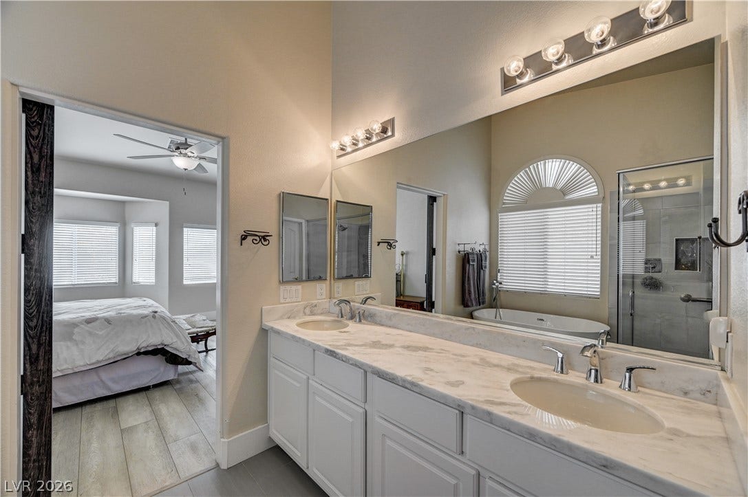 2201 Double Tree Avenue, Henderson, NV 89052 A spacious double vanity features polished stone countertops under high ceilings.