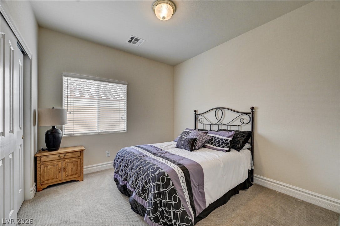 2201 Double Tree Avenue, Henderson, NV 89052 Plush carpeting and deep baseboards anchor this peaceful, naturally lit bedroom retreat.