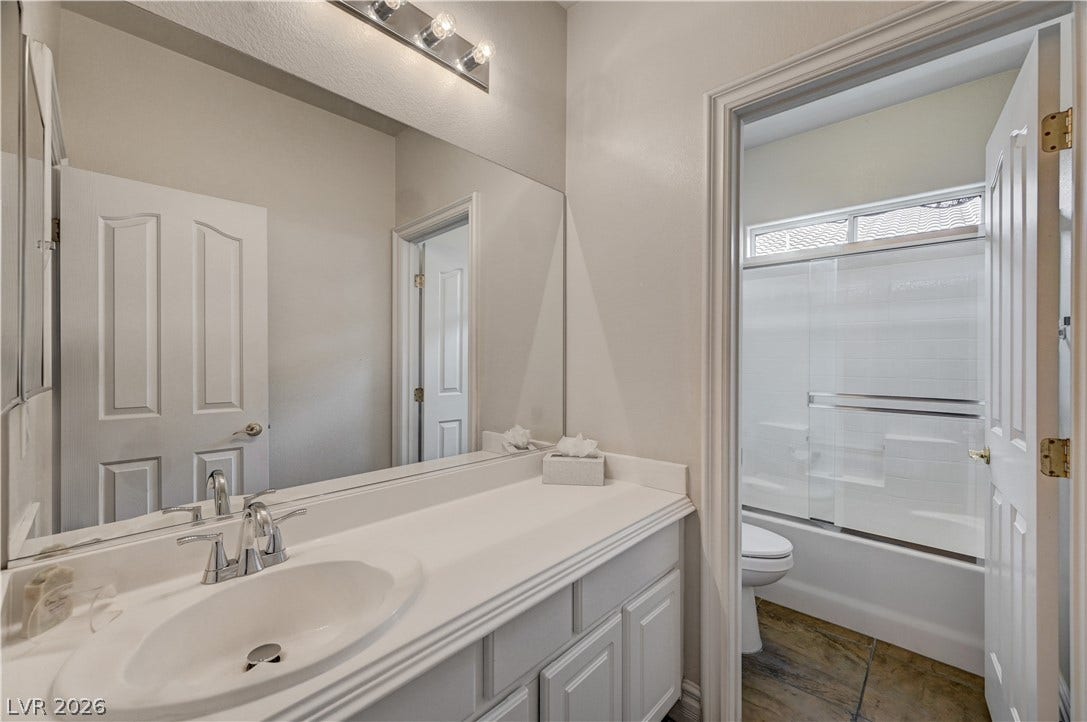 2201 Double Tree Avenue, Henderson, NV 89052 An integrated vanity countertop and matching cabinetry anchor this functional secondary bathroom layout.