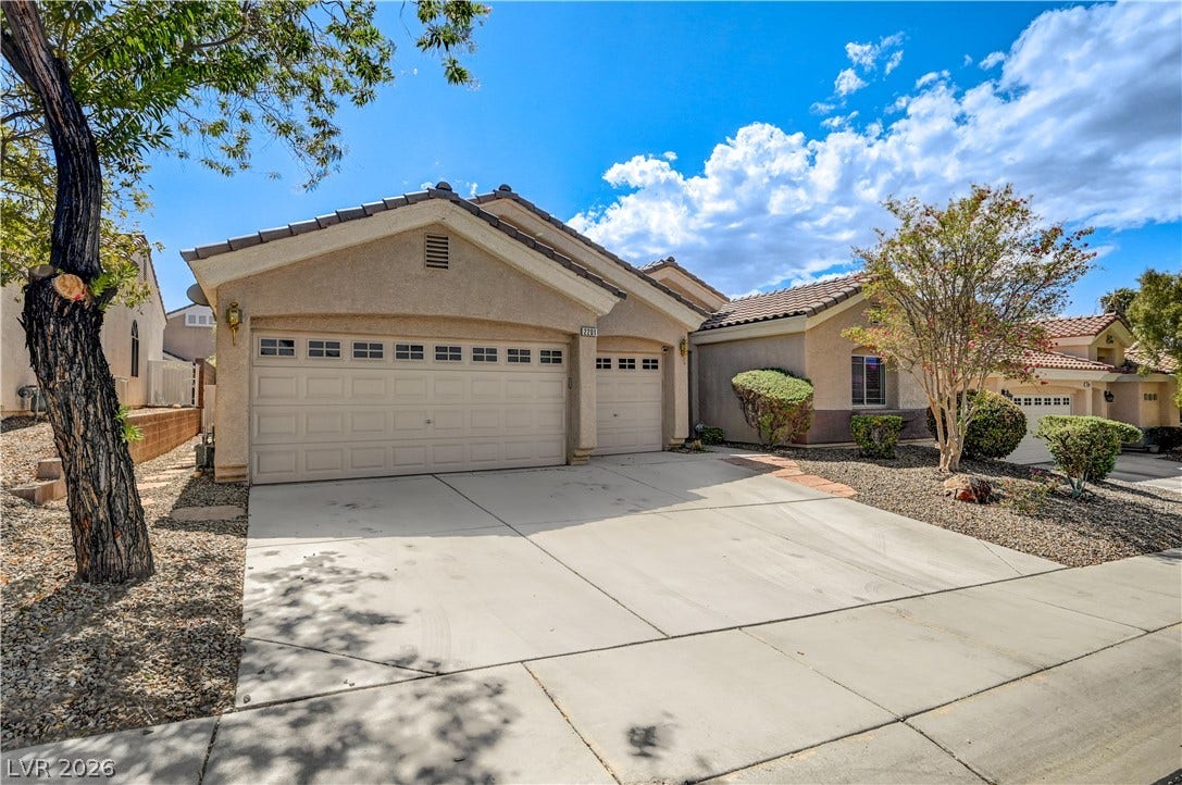 2201 Double Tree Avenue, Henderson, NV 89052 An inviting stucco exterior features a concrete driveway leading to a multi-car garage.