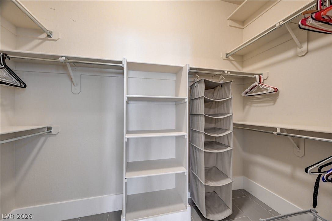 2201 Double Tree Avenue, Henderson, NV 89052 Ample built-in shelving and hanging rods maximize storage in this walk-in closet.