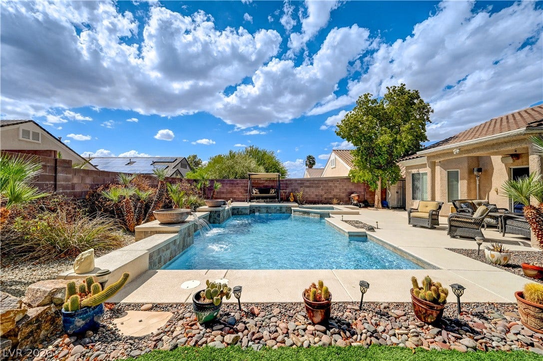 2201 Double Tree Avenue, Henderson, NV 89052 An inviting backyard oasis features a sparkling swimming pool, integrated spa, and paved sun terrace.