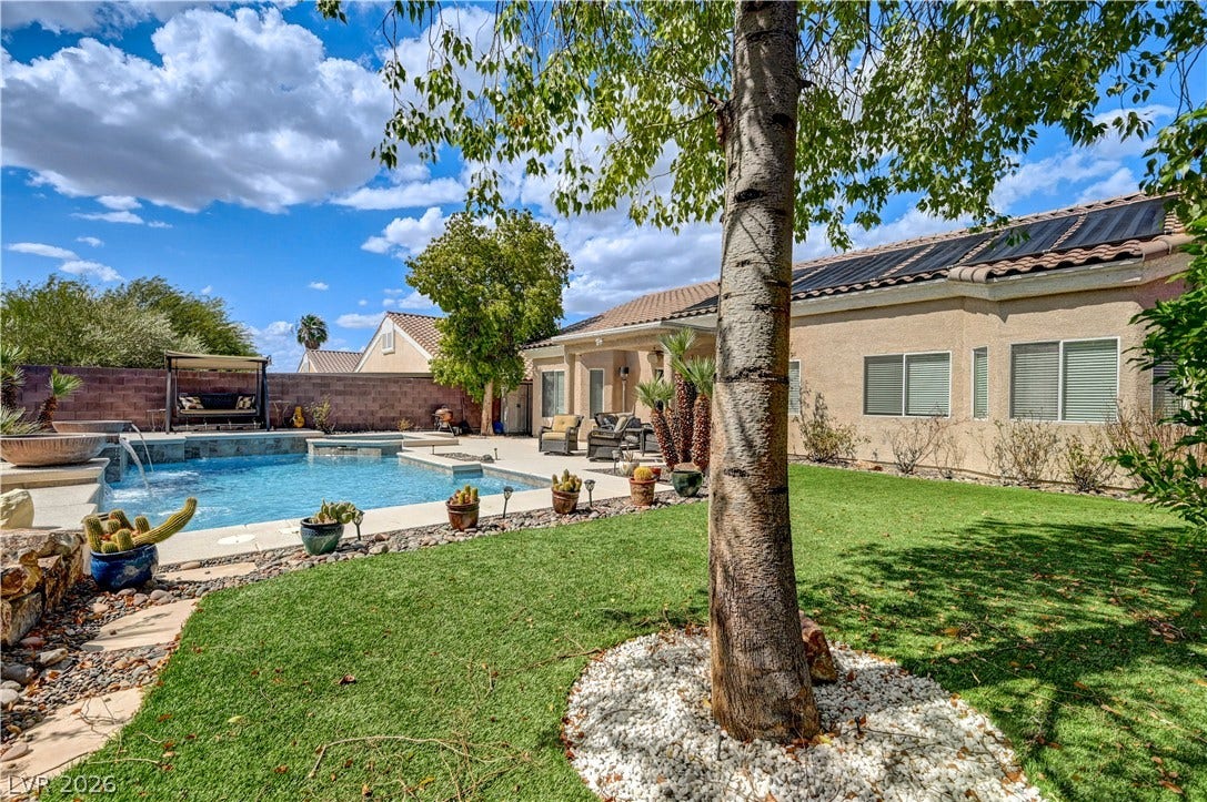 2201 Double Tree Avenue, Henderson, NV 89052 Mature trees and a manicured lawn frame a private pool and patio area.