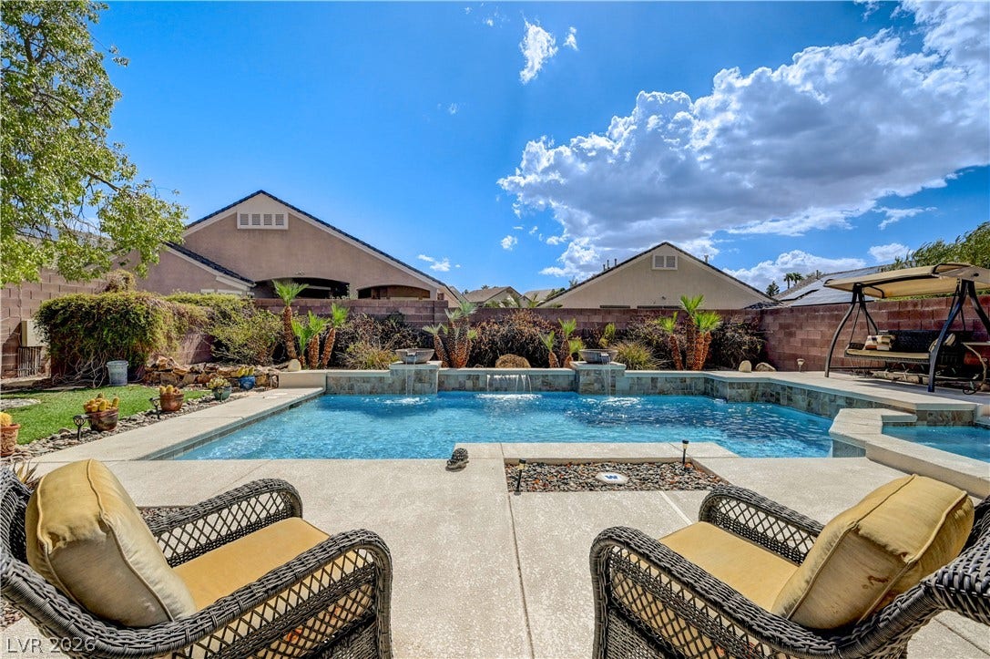 2201 Double Tree Avenue, Henderson, NV 89052 An inviting backyard oasis features a sparkling in-ground pool with stone water features and concrete decking.