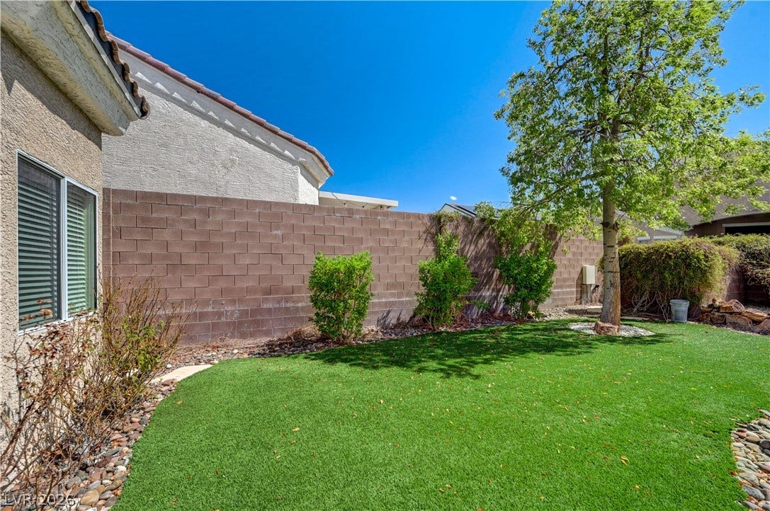 2201 Double Tree Avenue, Henderson, NV 89052 An enclosed grassy yard provides a private outdoor retreat bordered by a block wall.