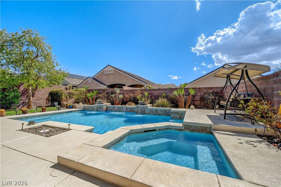 2201 Double Tree Avenue, Henderson, NV 89052 An inviting backyard oasis features a swimming pool with integrated spa and stone details.