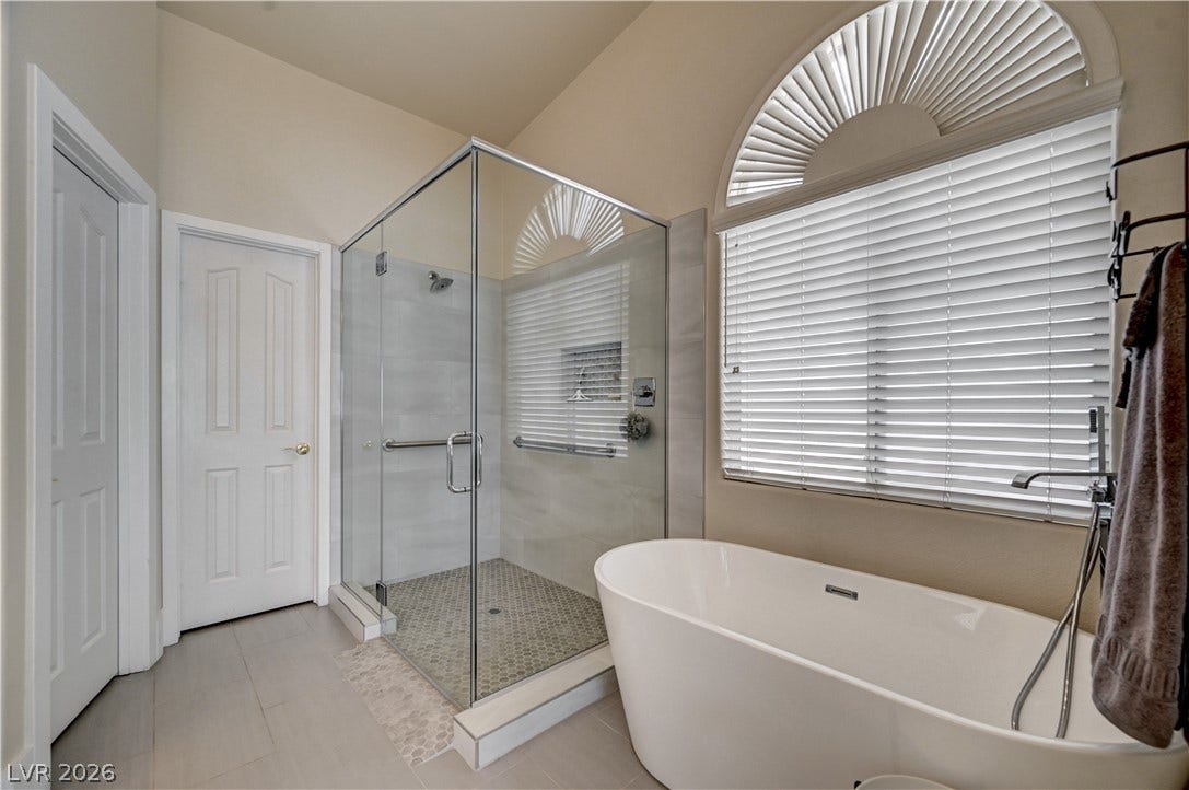 2201 Double Tree Avenue, Henderson, NV 89052 High ceilings and a glass-enclosed shower complement the elegant freestanding tub.