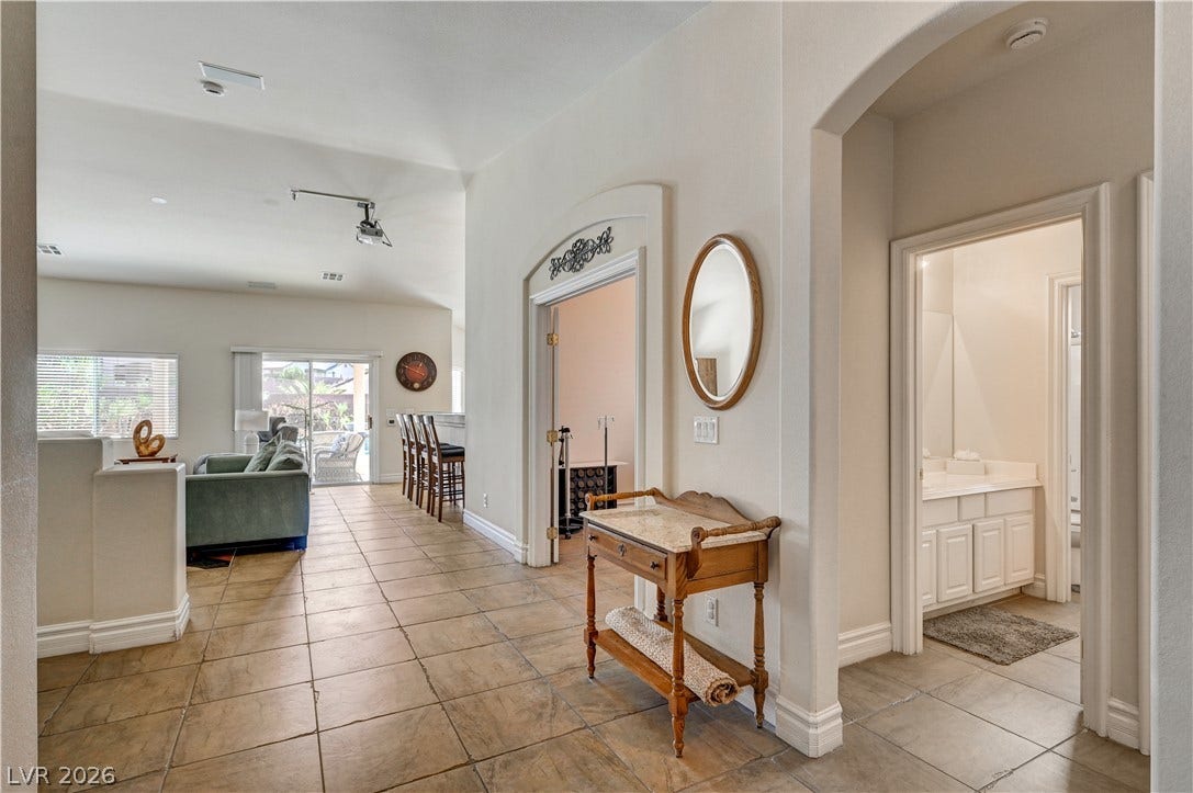 2201 Double Tree Avenue, Henderson, NV 89052 Arched doorways and tile flooring guide you through this inviting open-concept entryway.