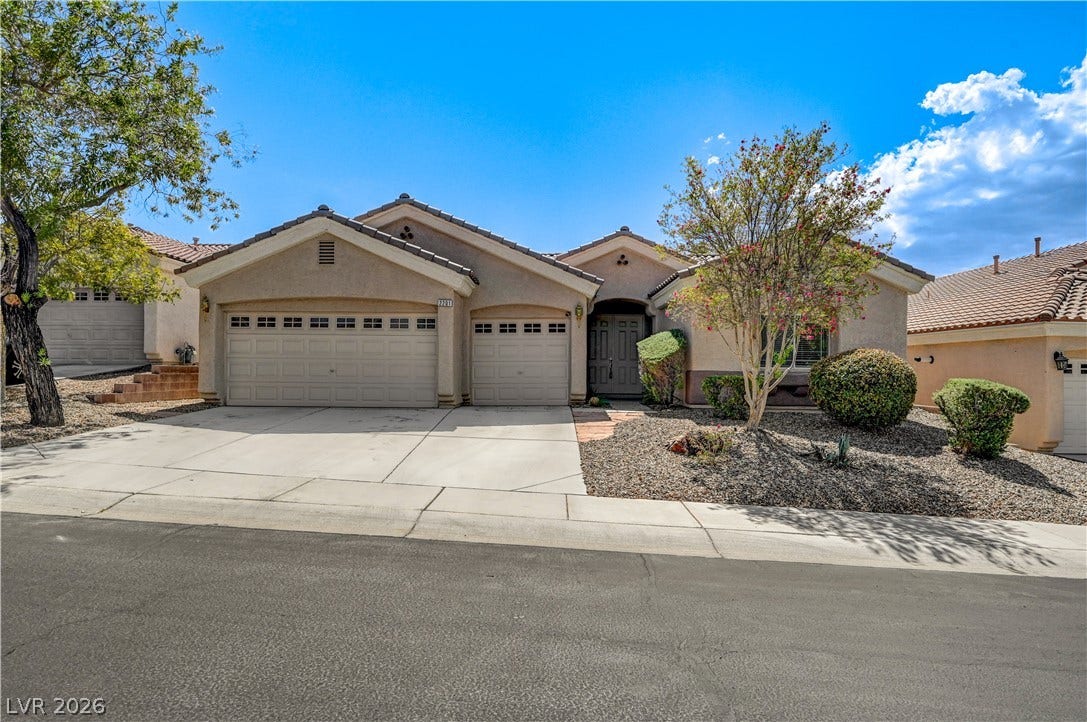 2201 Double Tree Avenue, Henderson, NV 89052 A spacious concrete driveway leads to this classic stucco exterior with an integrated garage.