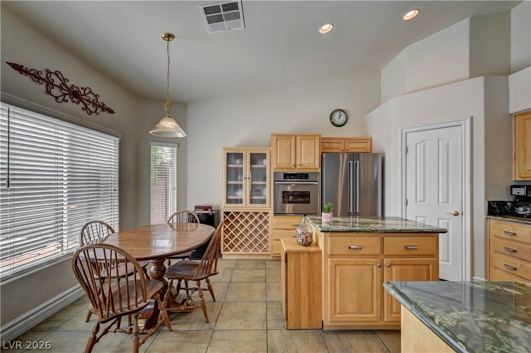 2201 Double Tree Avenue, Henderson, NV 89052 Gleaming tile floors anchor this cooking space featuring a central island and vaulted ceiling.