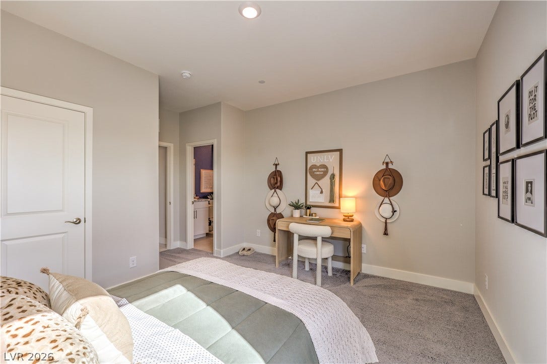 1032 Gentle Swan Street, Henderson, NV 89011 Recessed lighting and soft carpeting create a cozy, comfortable atmosphere in this bedroom.