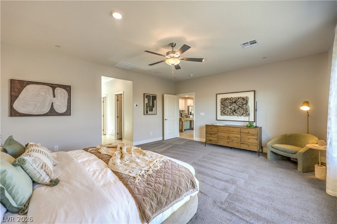 1032 Gentle Swan Street, Henderson, NV 89011 Recessed lighting and plush carpeting define this spacious, modern bedroom suite.