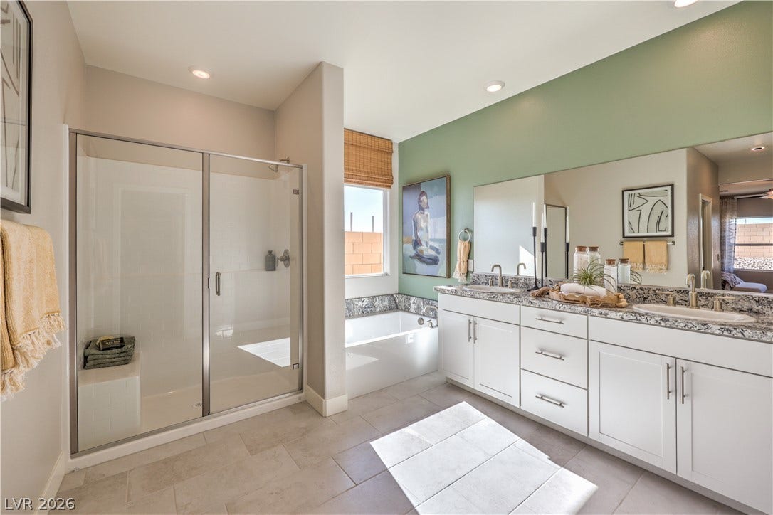 1032 Gentle Swan Street, Henderson, NV 89011 A spacious layout showcases a double vanity alongside a walk-in shower and separate soaking tub.