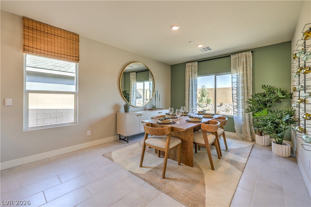 1032 Gentle Swan Street, Henderson, NV 89011 Recessed lighting illuminates this dining room featuring tiled flooring and sliding glass doors.