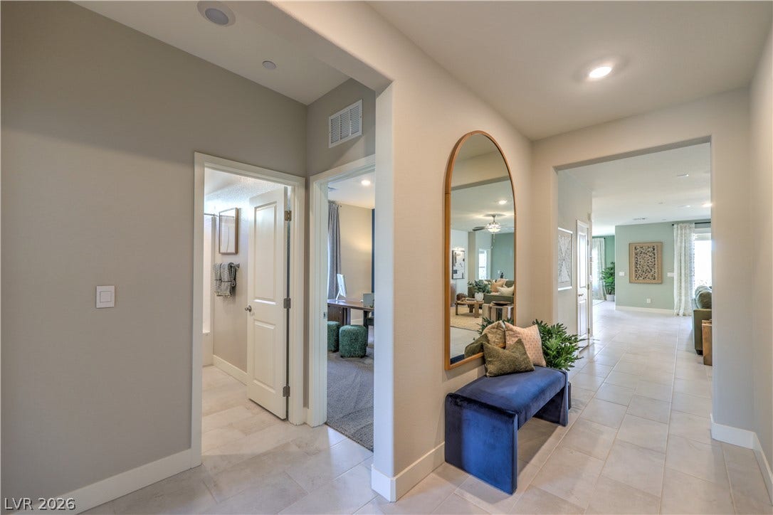 1032 Gentle Swan Street, Henderson, NV 89011 A welcoming entryway transitions into an open floorplan with recessed lighting and tiled flooring.