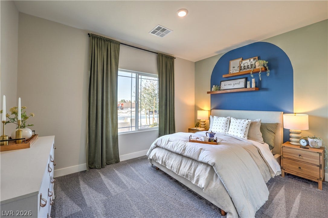 1032 Gentle Swan Street, Henderson, NV 89011 A sunny window illuminates plush carpet and tall ceilings in this comfortable bedroom.