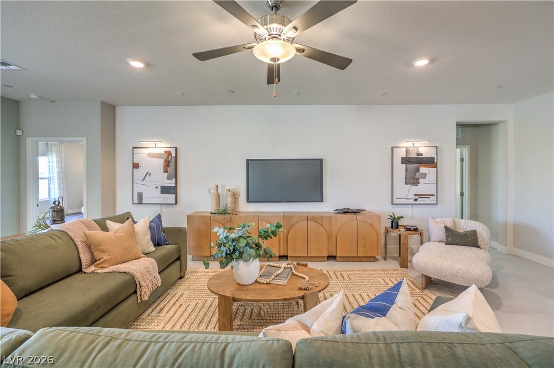 1032 Gentle Swan Street, Henderson, NV 89011 Smooth tile floors and high ceilings with recessed lighting define this comfortable living space.