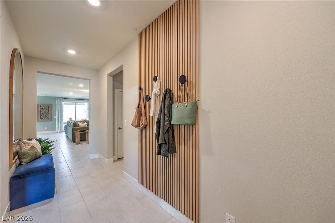 1032 Gentle Swan Street, Henderson, NV 89011 A welcoming entryway showcases clean tile flooring and built-in vertical wood paneling.