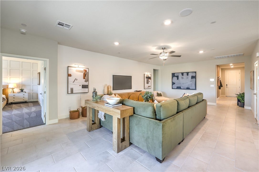 1032 Gentle Swan Street, Henderson, NV 89011 An open floorplan showcases smooth tile flooring and seamless transitions between light-filled living spaces.