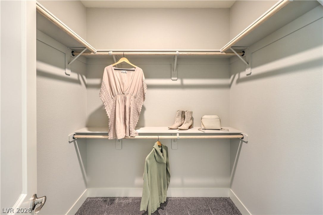 1032 Gentle Swan Street, Henderson, NV 89011 Ample built-in shelving and hanging rods maximize storage space inside this walk-in closet.