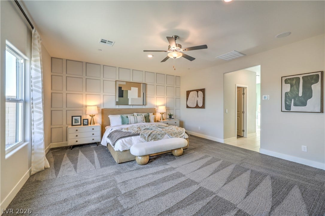 1032 Gentle Swan Street, Henderson, NV 89011 An elegant panel accent wall and plush carpeting define this restful sleeping space.