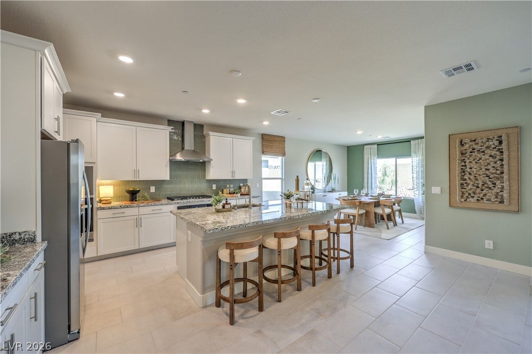 1032 Gentle Swan Street, Henderson, NV 89011 Gleaming tile floors and granite counters anchor this beautifully appointed open-concept kitchen.