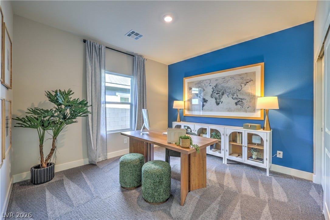 1032 Gentle Swan Street, Henderson, NV 89011 A quiet home workspace featuring soft wall-to-wall carpeting and a tall window.