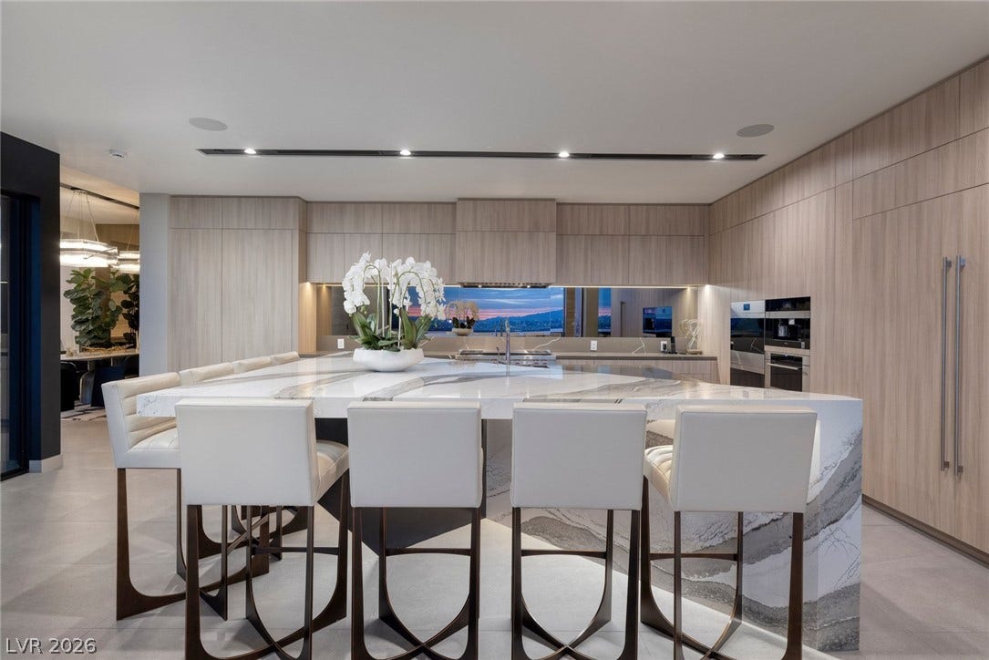 705 Dragon Peak Drive, Henderson, NV 89012 Streamlined cabinetry and premium stone surfaces define this architecturally refined kitchen.