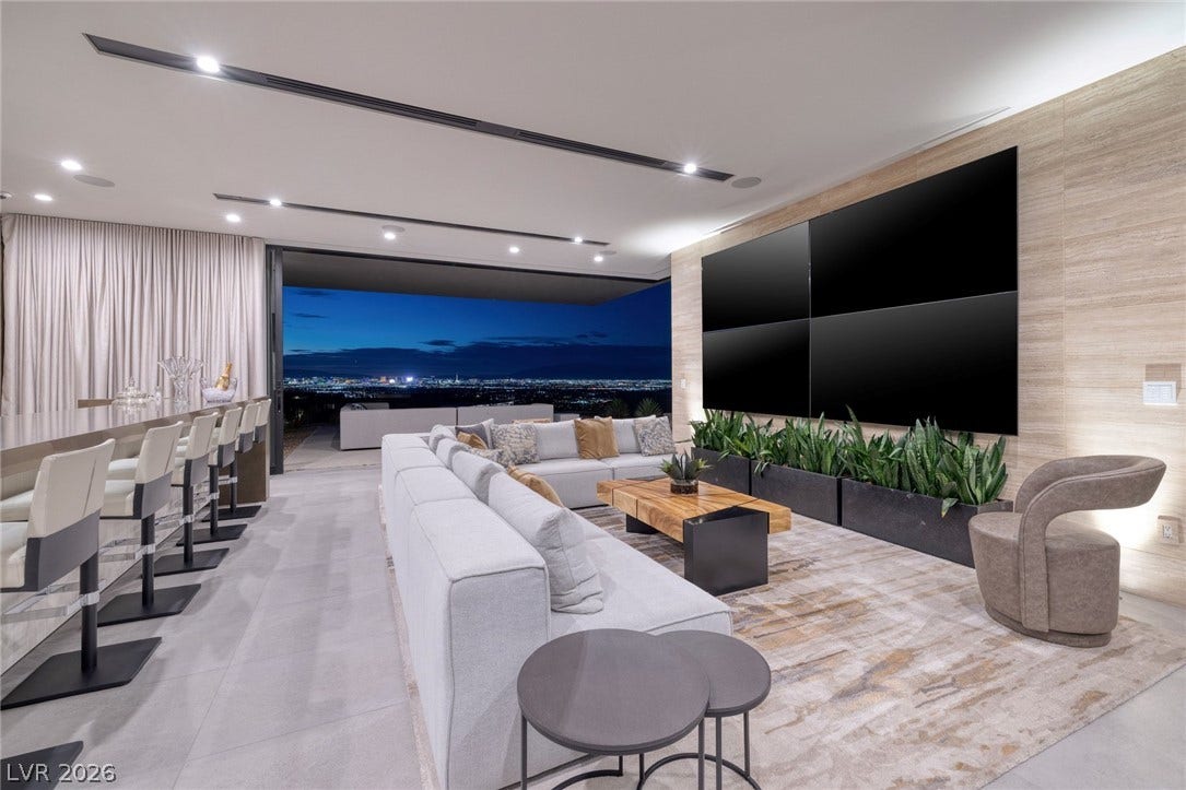705 Dragon Peak Drive, Henderson, NV 89012 An open-concept living area overlooks twinkling city lights through massive sliding glass doors.