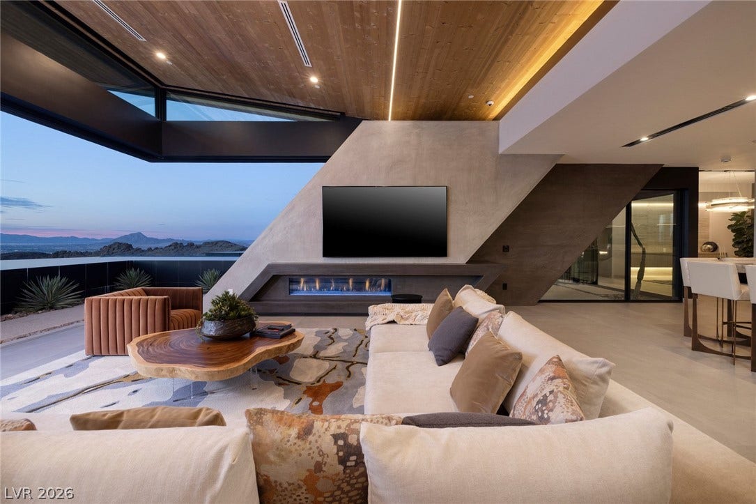 705 Dragon Peak Drive, Henderson, NV 89012 Dramatic architectural angles and a sleek modern fireplace frame sweeping mountain views.